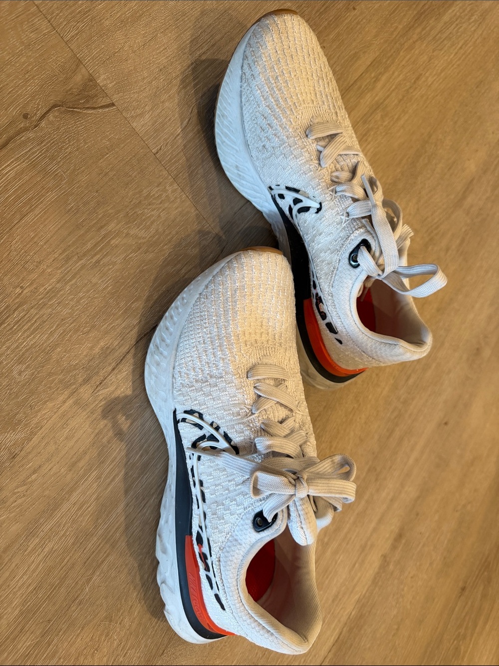 Nike Women's White Running Shoes with Black and Orange Accents